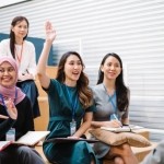 Shot of a businesswoman raising her hand during a conference